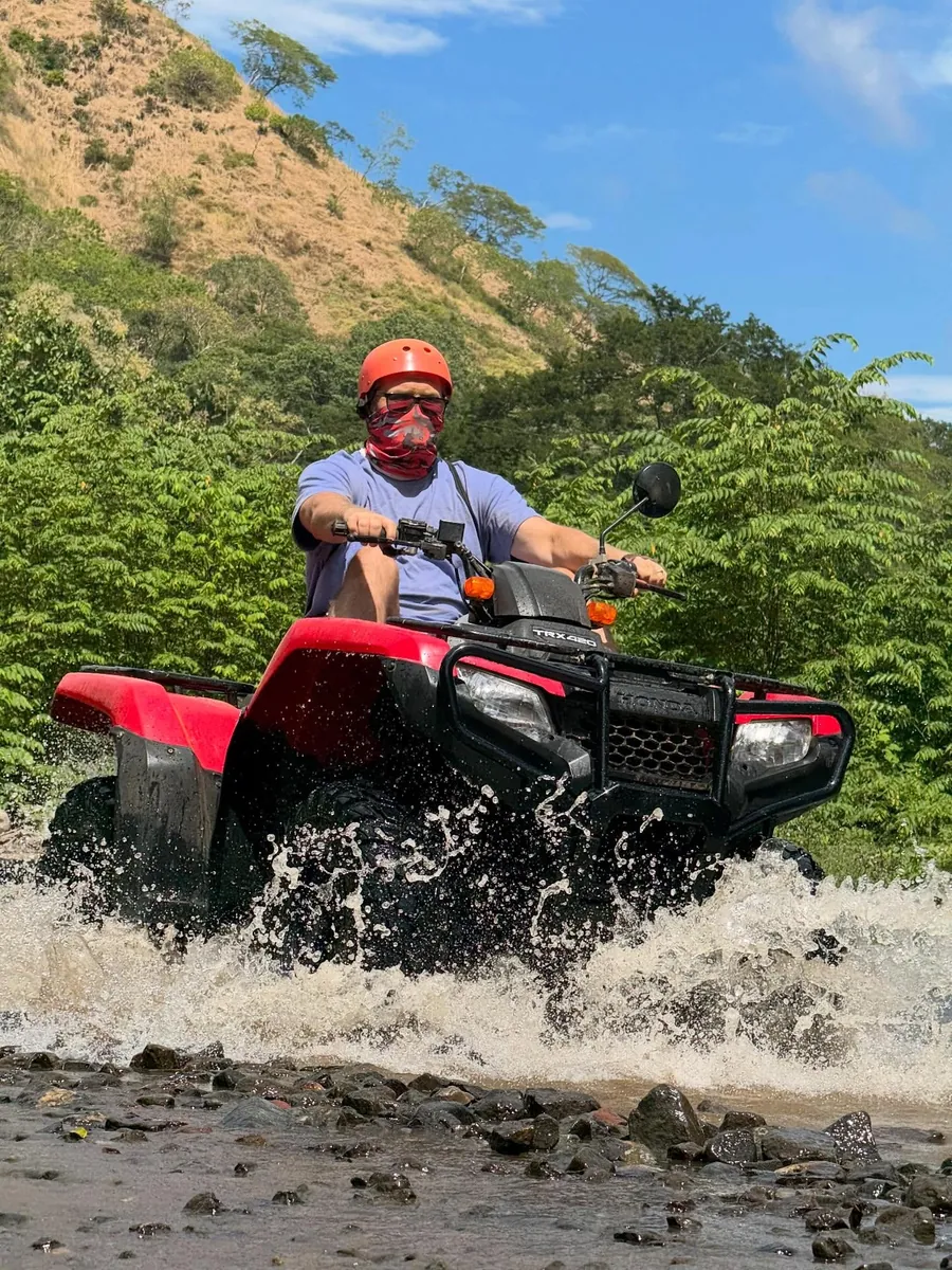 ATV crossing a river on an adventure experience in Guanacaste, Costa Rica