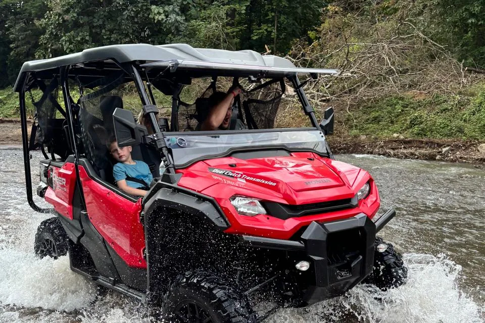 ATV riders on a mountain trail with countryside views in Guanacaste, Costa Rica