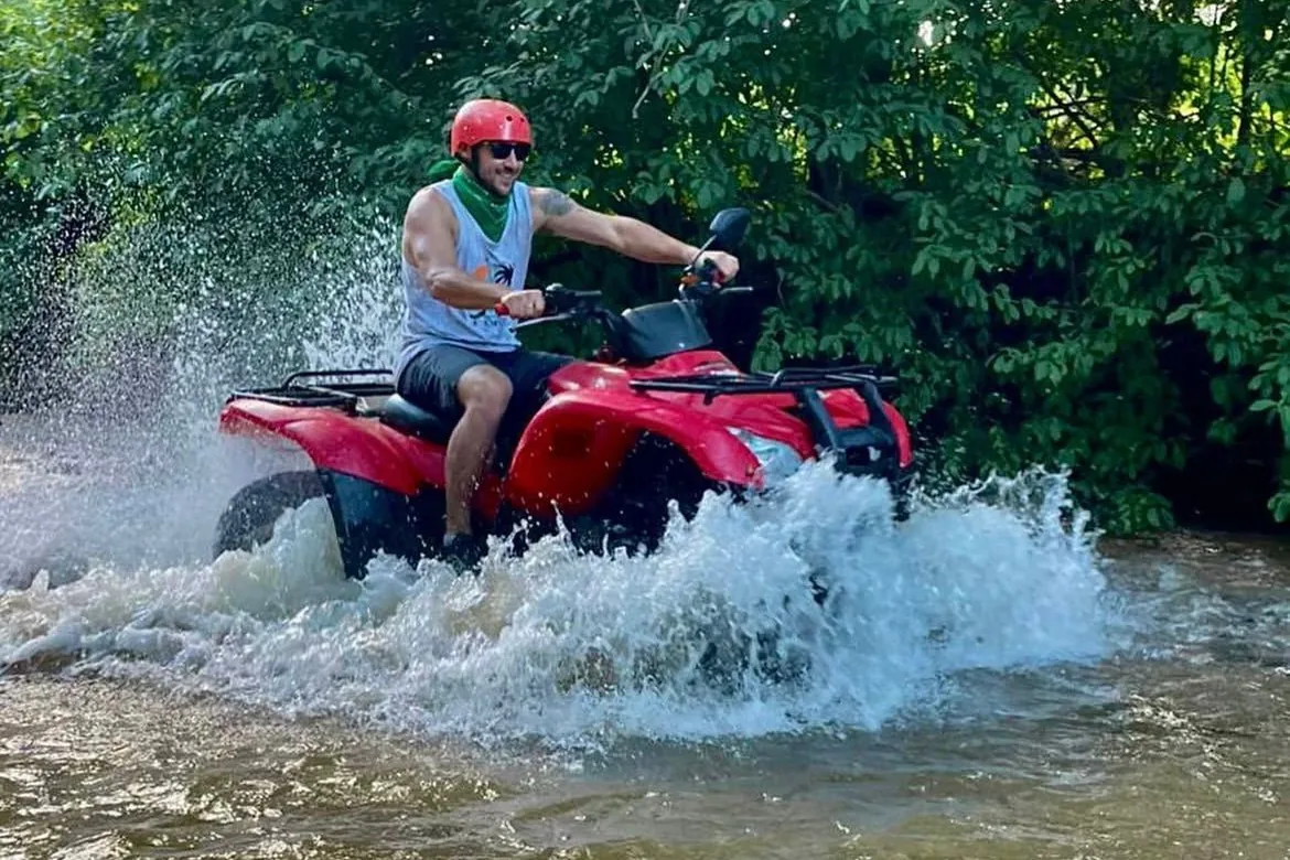ATV splashing through a river crossing on an off-road tour, Guanacaste, Costa Rica