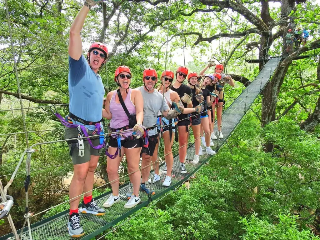 Group crossing a canopy hanging bridge on a zipline tour in Guanacaste, Costa Rica