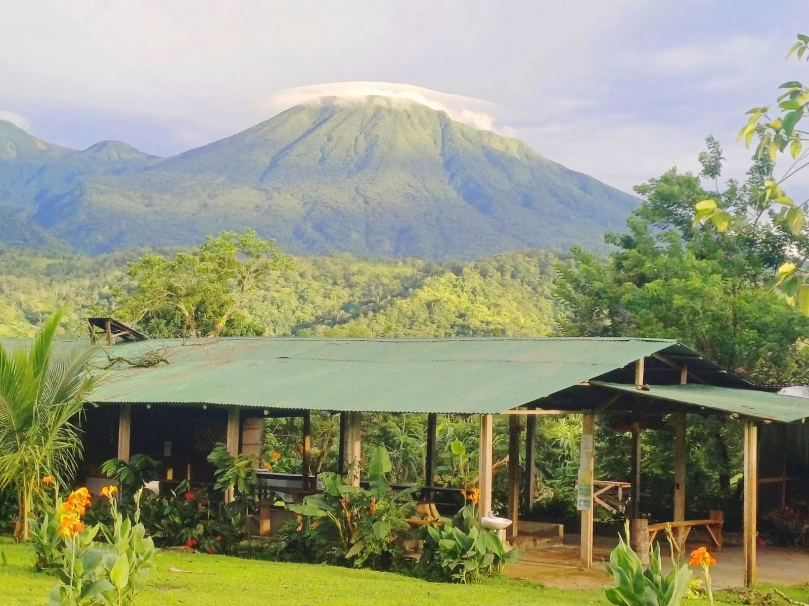 Family farm with Tenorio Volcano behind it on a chocolate and coffee tour in Costa Rica