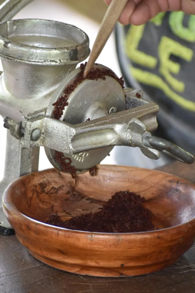 Fresh chocolate ground by hand into a wooden bowl on a Costa Rica chocolate tour