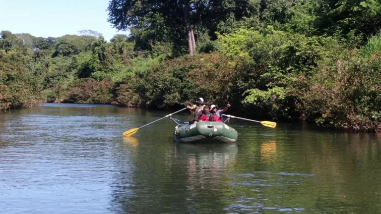 Guide pointing out wildlife from the raft on a Corobici river float tour, Guanacaste