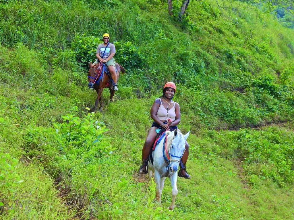 Riders on a horseback trail on a green hillside at Congo Trail, Guanacaste, Costa Rica
