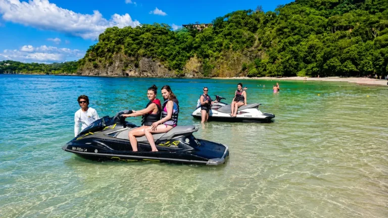 Riders on jet skis in the shallows of a Guanacaste beach, Costa Rica