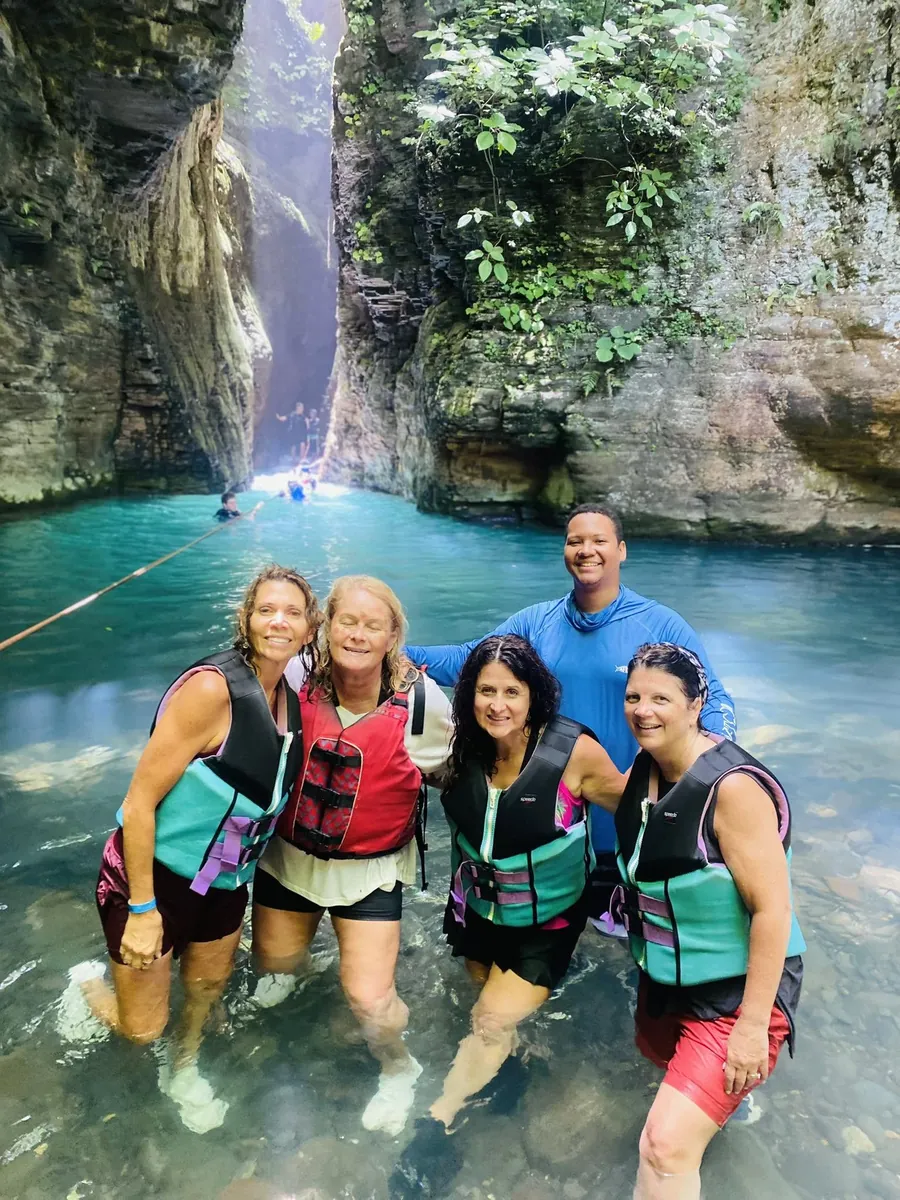 Tour group in life jackets in the La Leona canyon pool, Guanacaste, Costa Rica