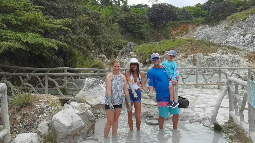 Family enjoying the volcanic mud bath at Miravalles, hot springs tour, Guanacaste, Costa Rica