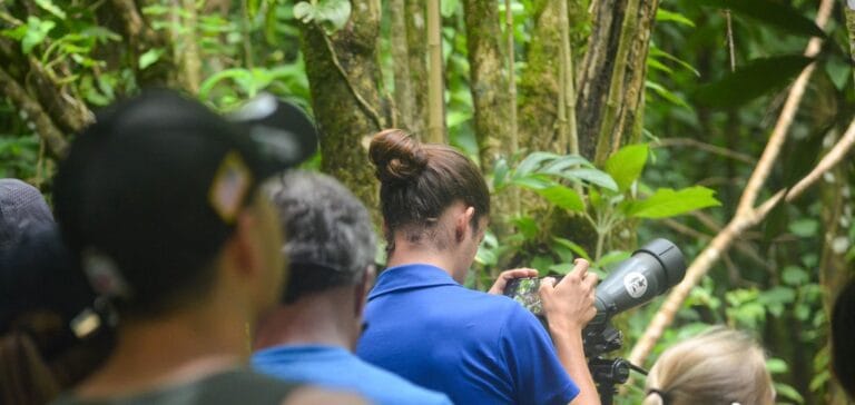 Visitors photographing wildlife with a telephoto lens on the rainforest trail, Tenorio, Costa Rica