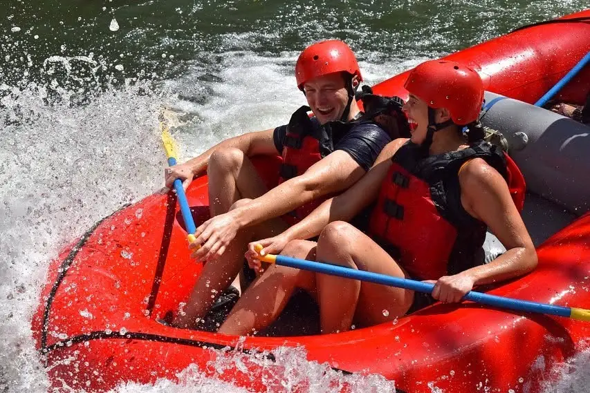 Two rafters laughing through a whitewater splash, Tenorio River