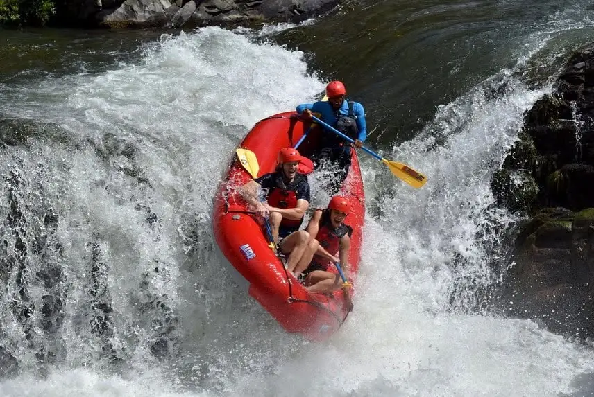 Red raft plunging down a waterfall on the Tenorio River, Guanacaste