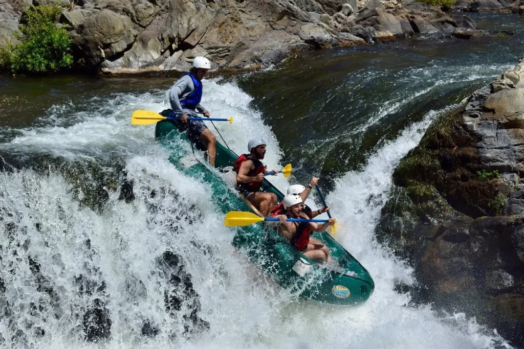 Rafters descending a waterfall on a Tenorio River rafting tour