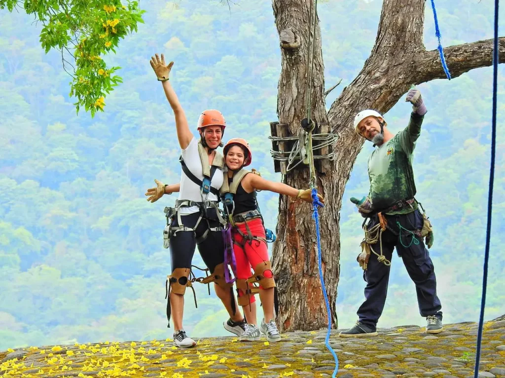 Family with a certified guide at a zip-line platform with mountain views in Guanacaste, Costa Rica
