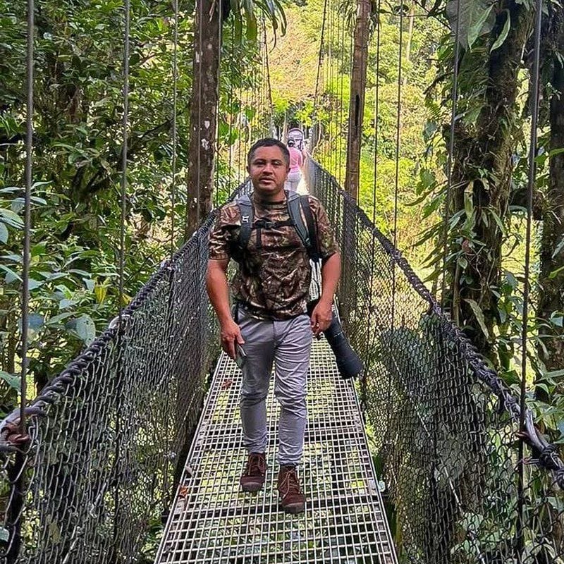 Obed Canales, naturalist guide and wildlife photographer on a rainforest hanging bridge — Guanadreams CR