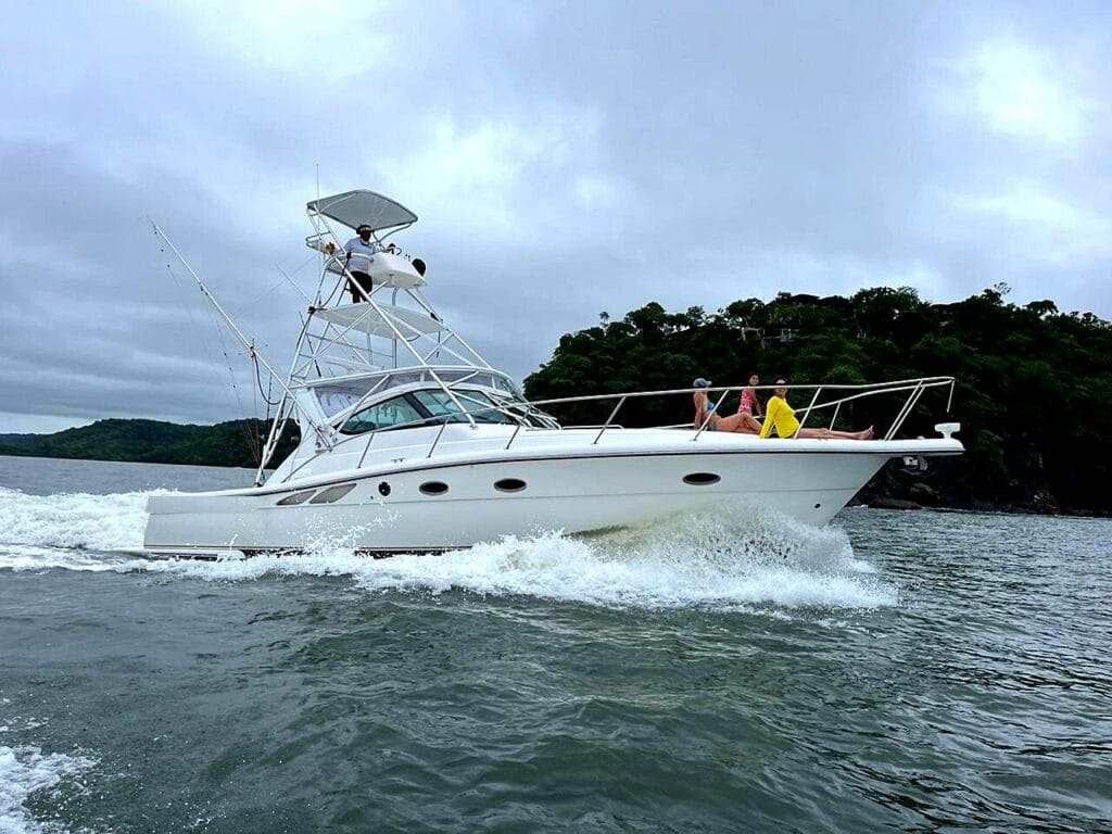 Guests relaxing on the bow of a private boat cruising the Gulf of Papagayo, Guanacaste, Costa Rica