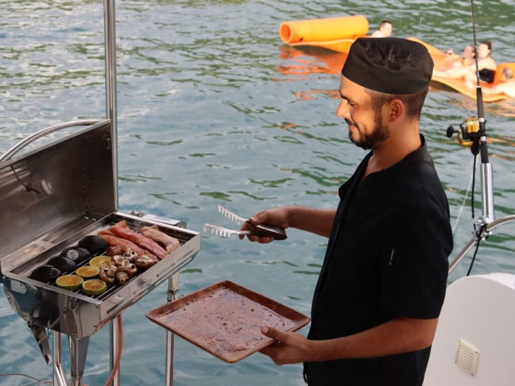 Private chef grilling on board a catamaran charter in the Gulf of Papagayo, Guanacaste, Costa Rica