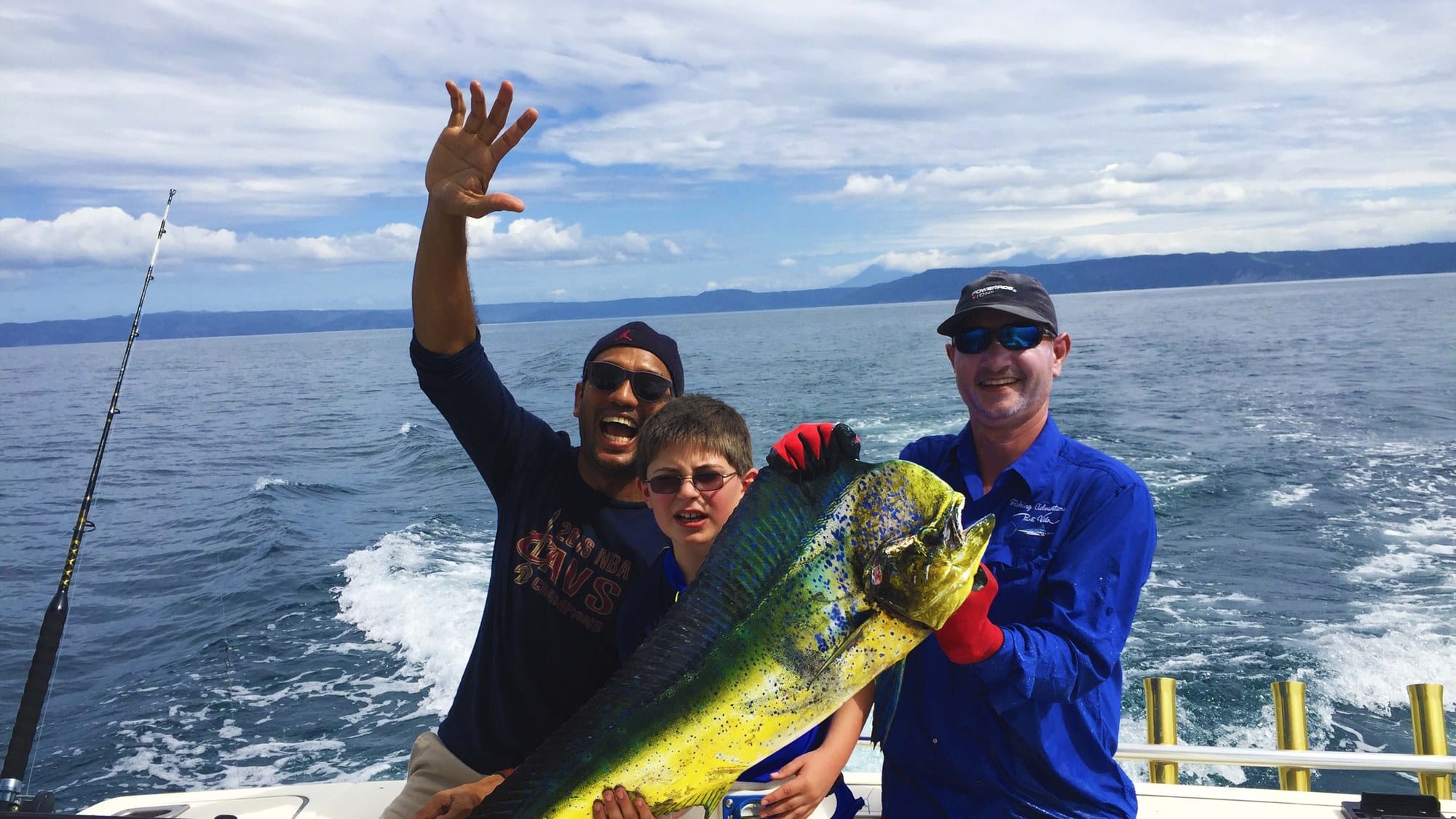 Guests holding a mahi-mahi caught on a private sport fishing charter in the Gulf of Papagayo, Guanacaste, Costa Rica
