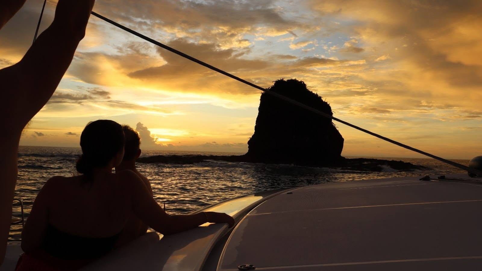 Guests watching the sunset from the deck of a private catamaran in the Gulf of Papagayo, Guanacaste, Costa Rica