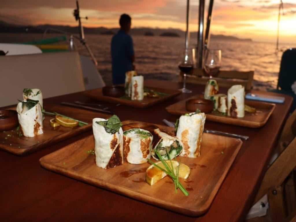 Dinner served on deck as the sun goes down on a private sunset sail in the Gulf of Papagayo, Guanacaste, Costa Rica