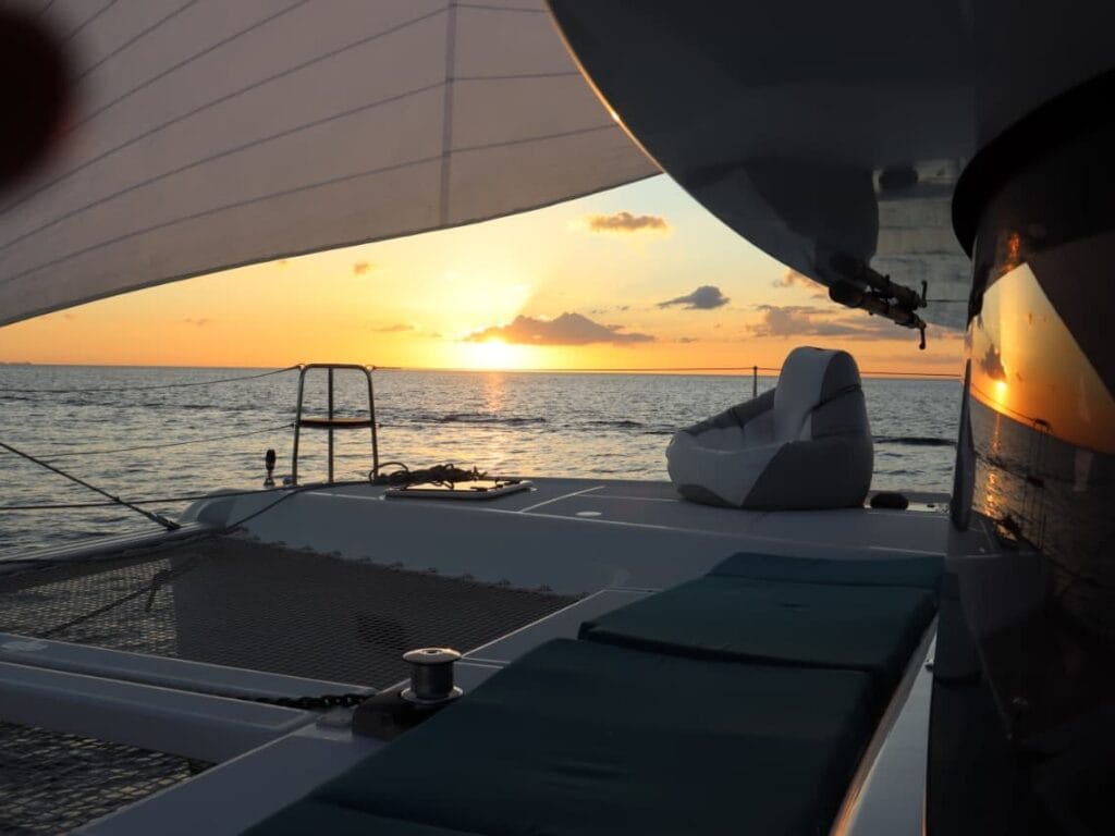 A catamaran under sail in golden-hour light in the Gulf of Papagayo, Guanacaste, Costa Rica