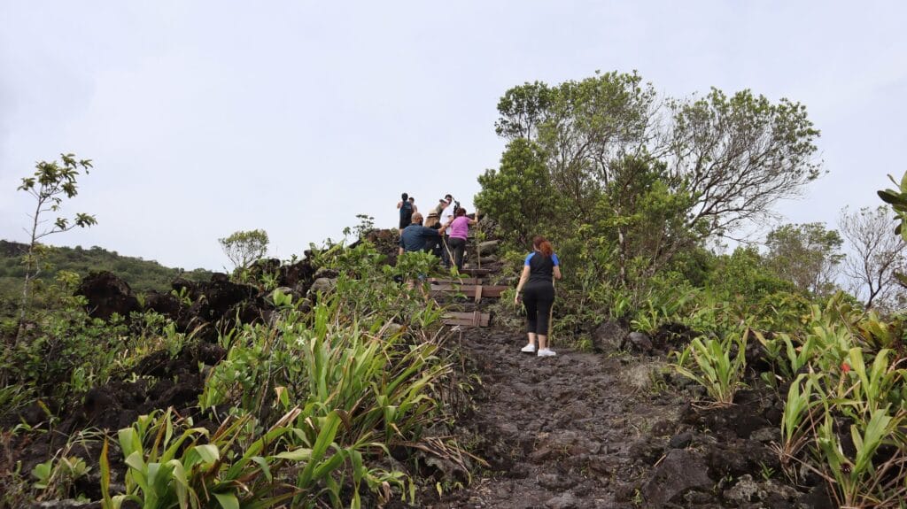 Uneven volcanic rock and built steps on the trail across the Arenal 1968 lava field