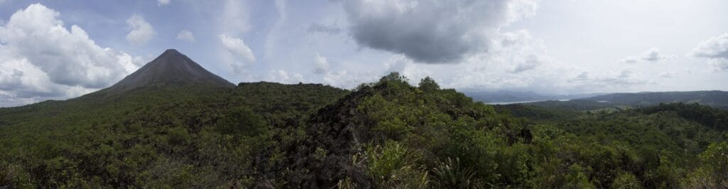 Panoramic view of Arenal Volcano and Lake Arenal from the lava field