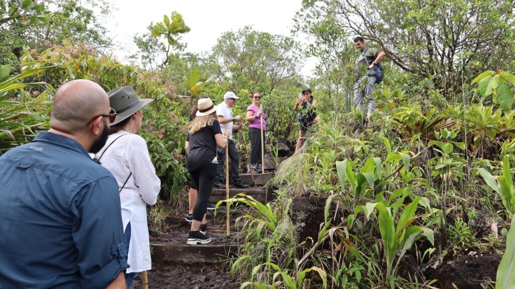 Small group climbing the stepped section of the 1968 lava trail on Arenal Volcano
