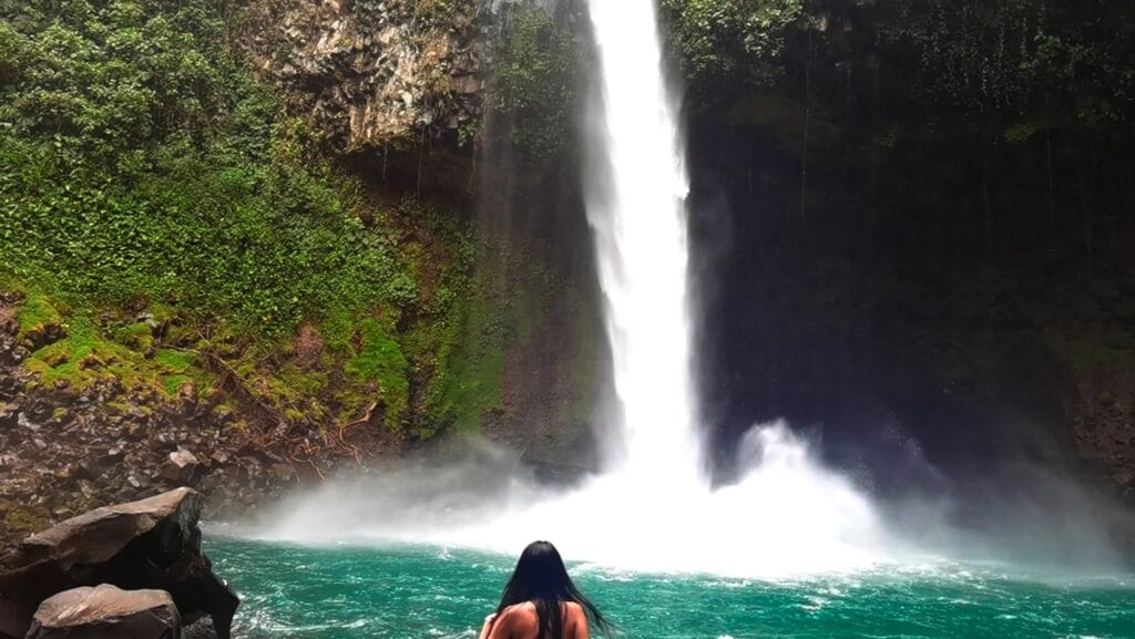 Swimming in the turquoise pool at the base of La Fortuna Waterfall, Costa Rica