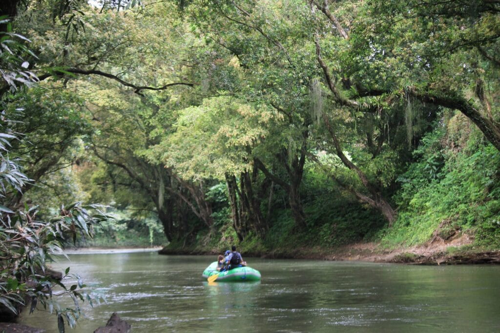 A raft drifting through rainforest on the Peñas Blancas river near Arenal, Costa Rica