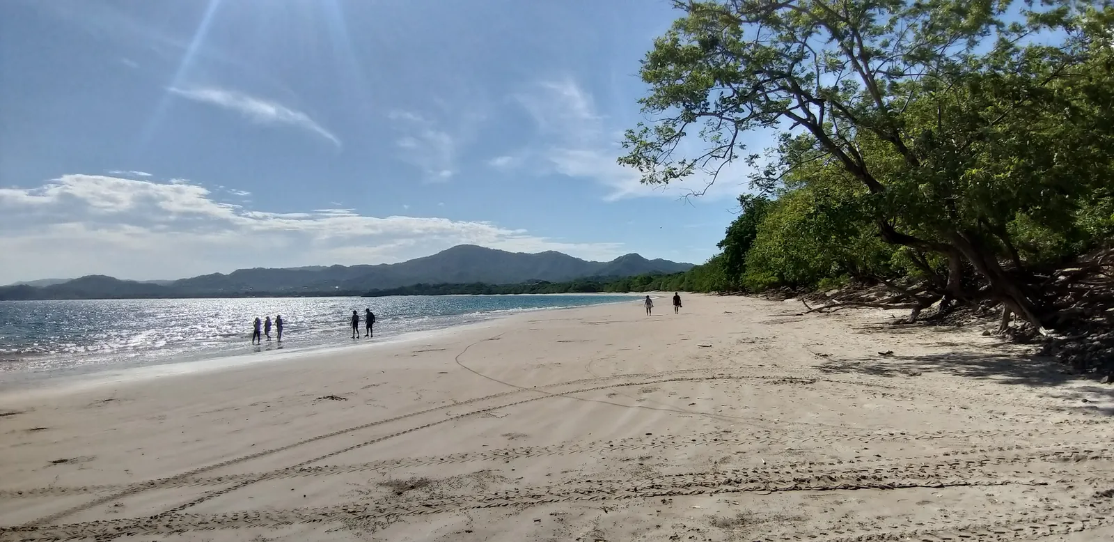 Wide sandy Guanacaste beach under clear skies on the North Pacific coast of Costa Rica