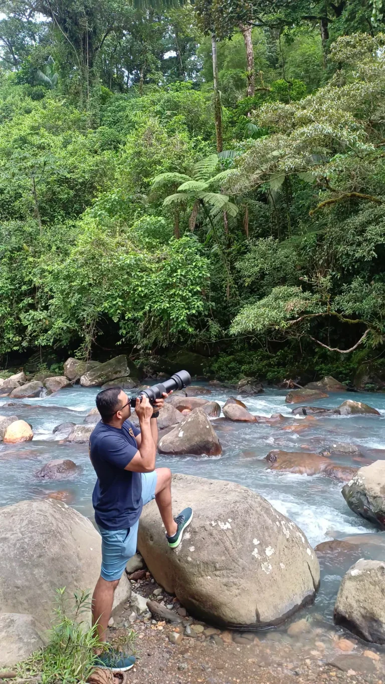 Miller Contreras, founder and lead naturalist guide of Guanadreams CR, photographing wildlife beside Río Celeste, Costa Rica